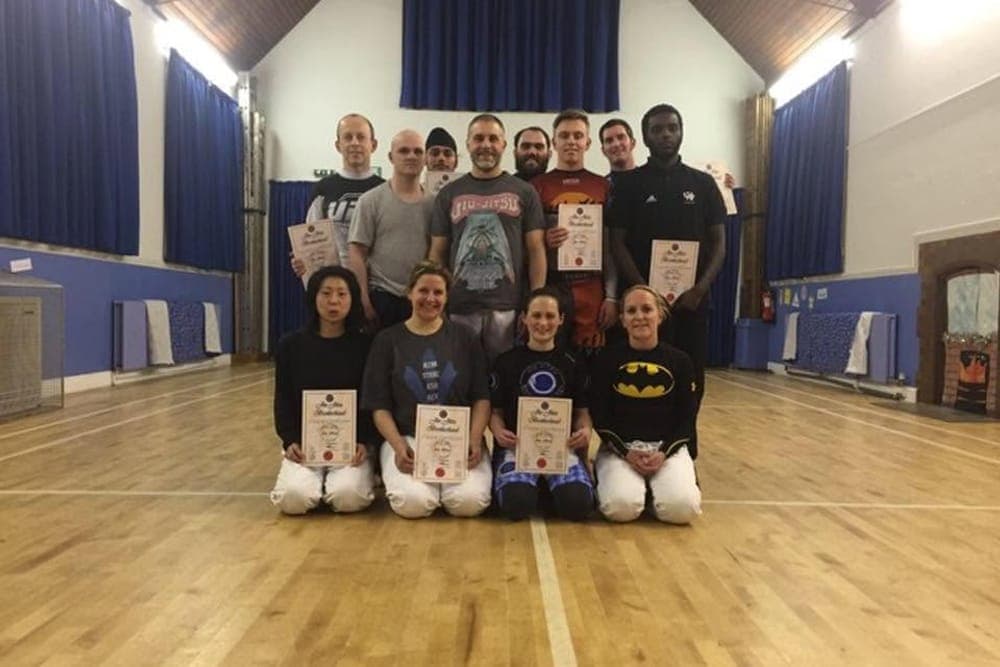 Kingston Jiu Jitsu beginners course group holding their certificates